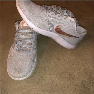 Grey Nike sneakers with gold metallic swoosh